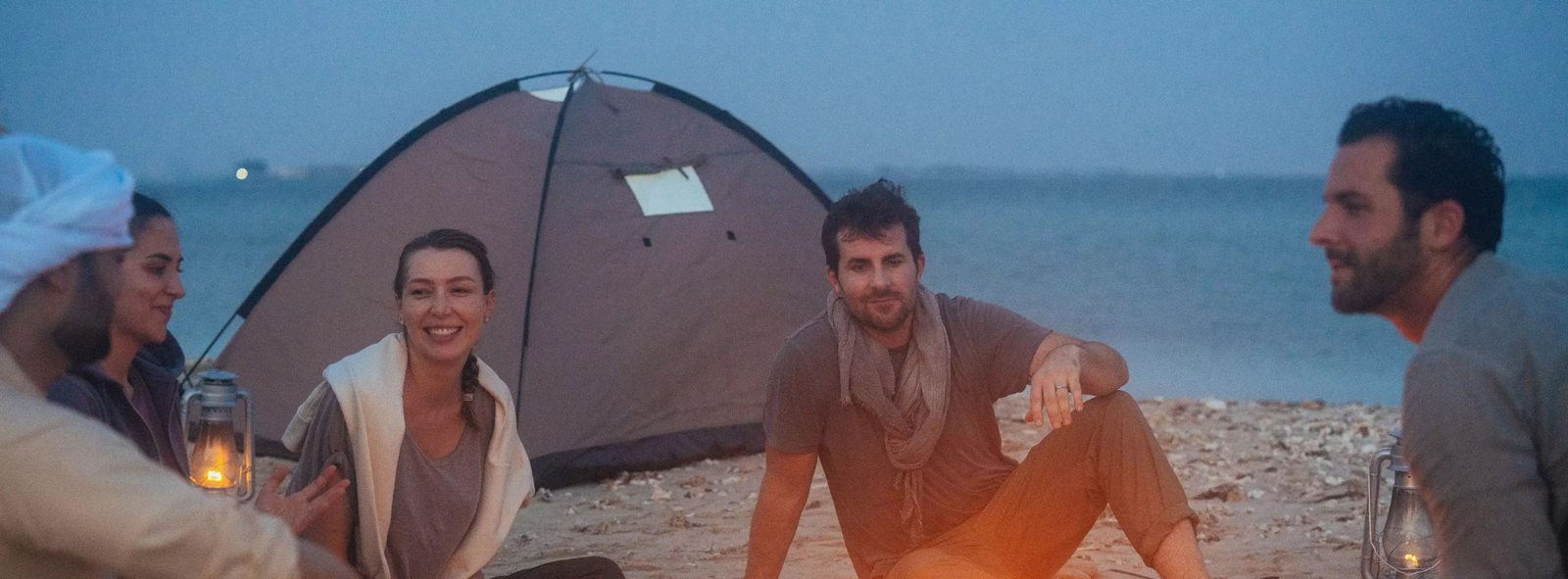 RV camping setup in the desert with tents and water nearby
