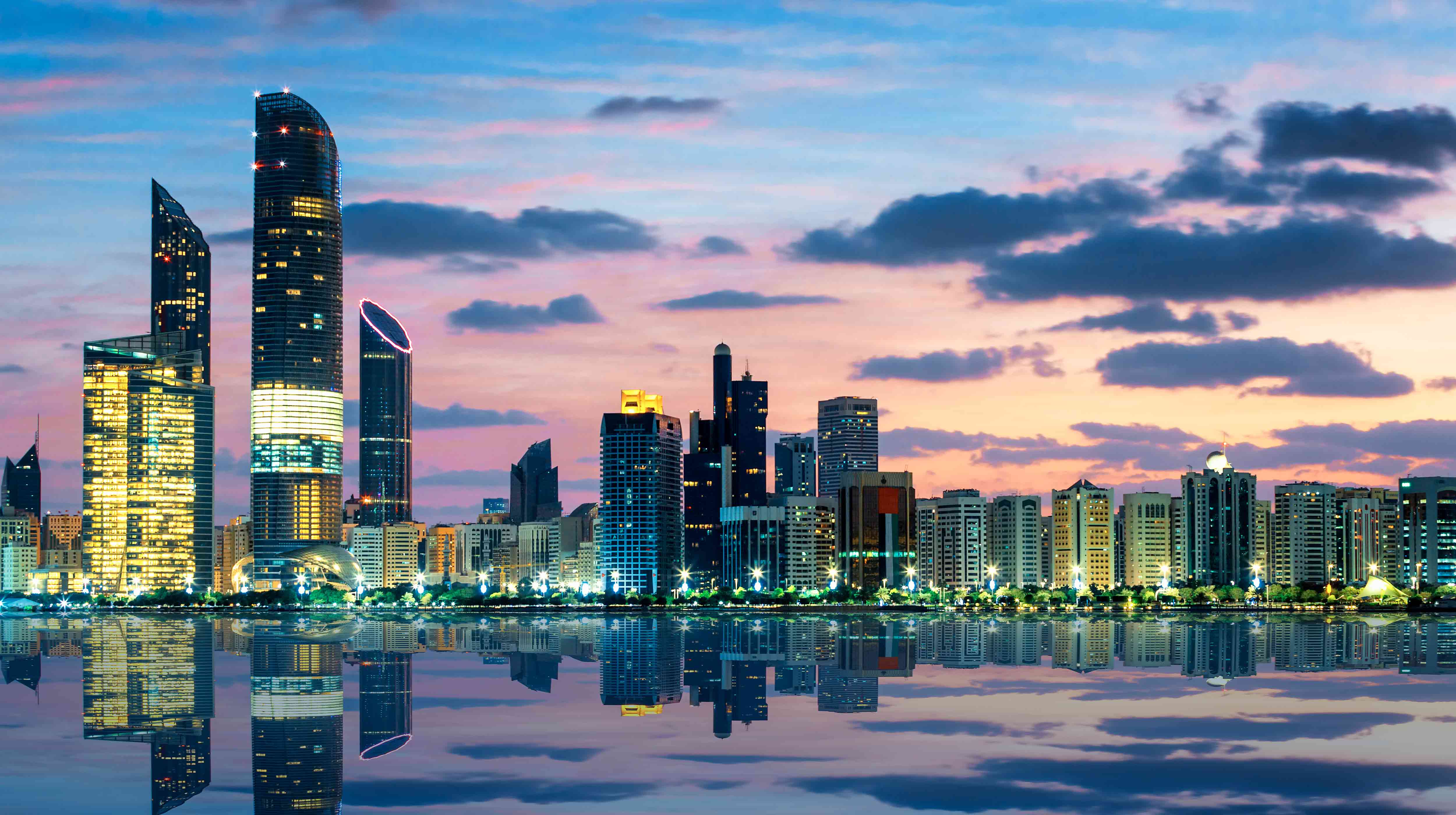 Twinkling view of Abu Dhabi skyline at dusk