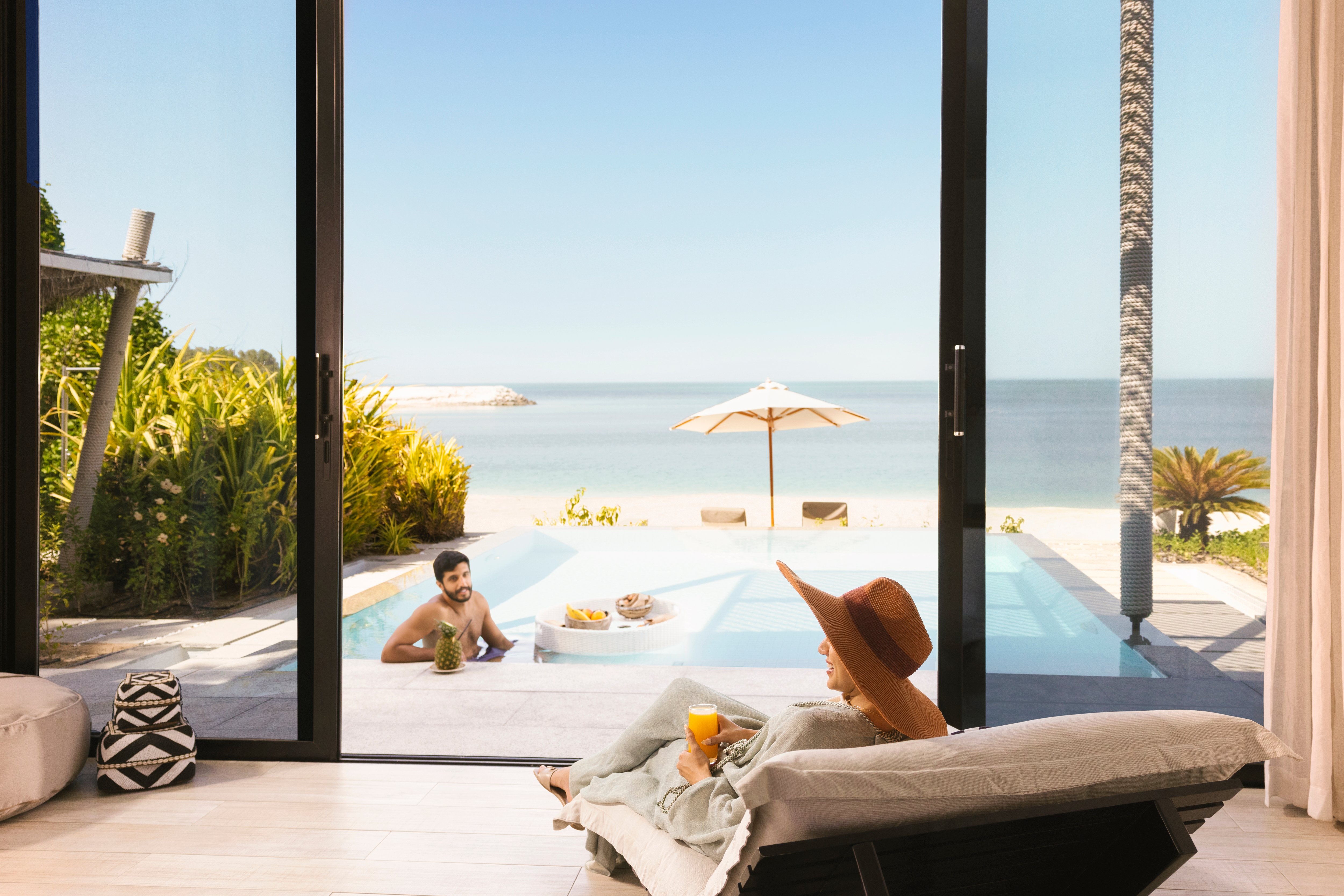 Western couple enjoying their luxury villa with a pool on Nurai Island