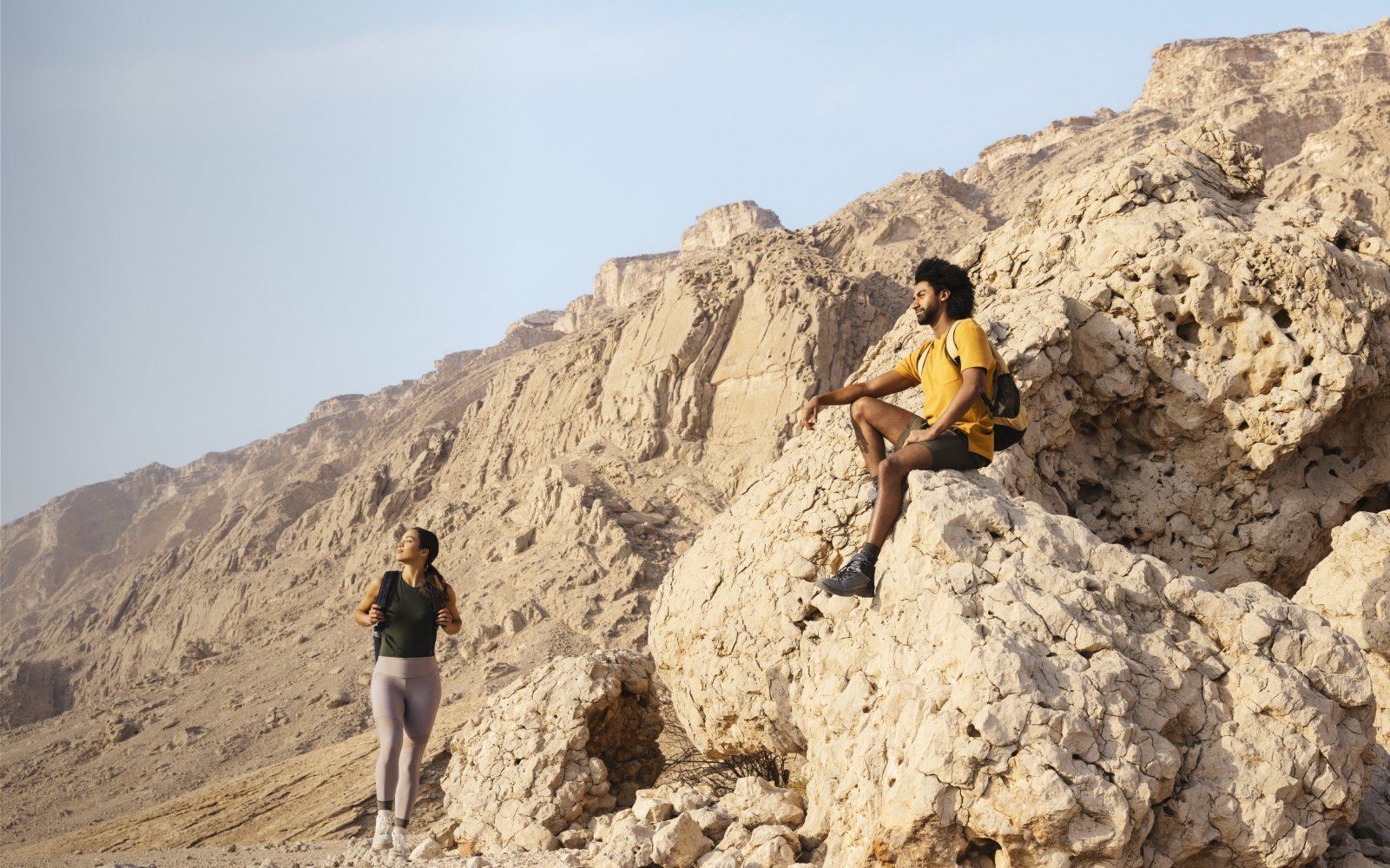 Western couple hiking in the mountains in Jebel Hafit Desert Park