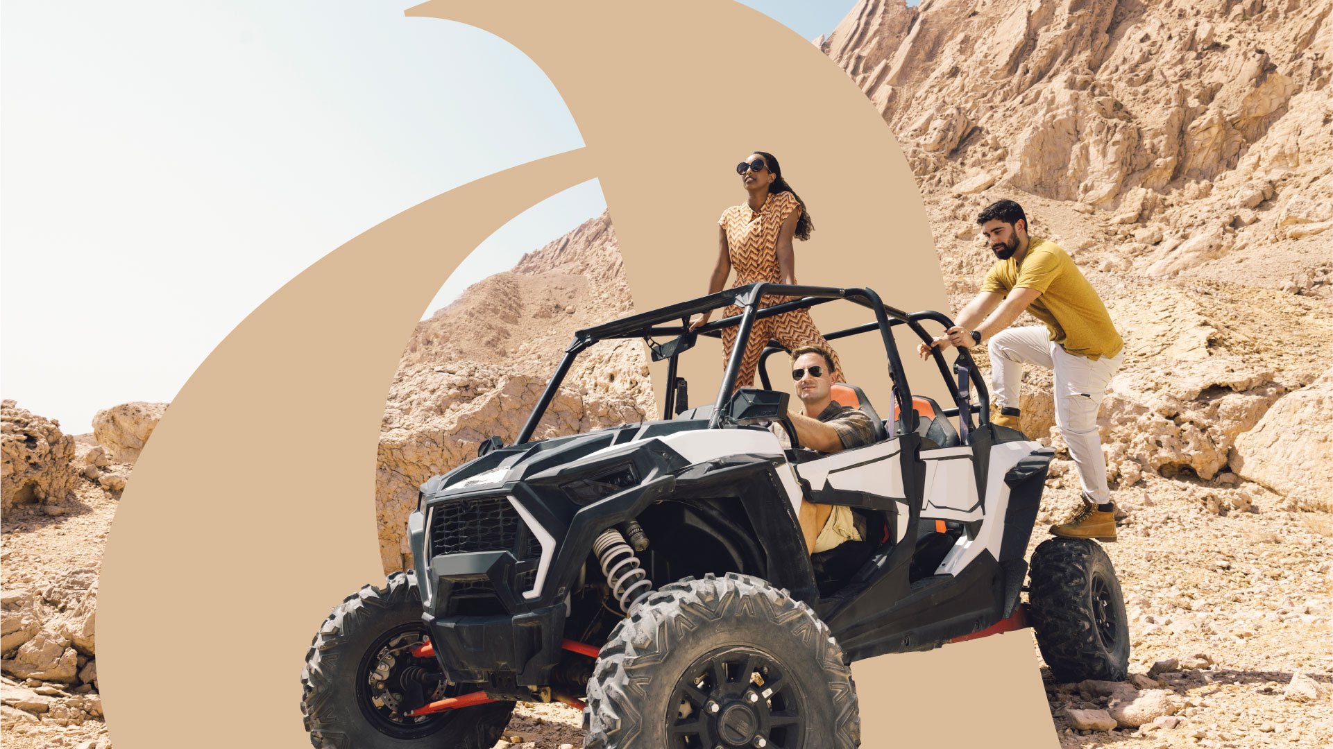 3 friends on an off road buggy in the Abu Dhabi dunes at Jebel Hafeet