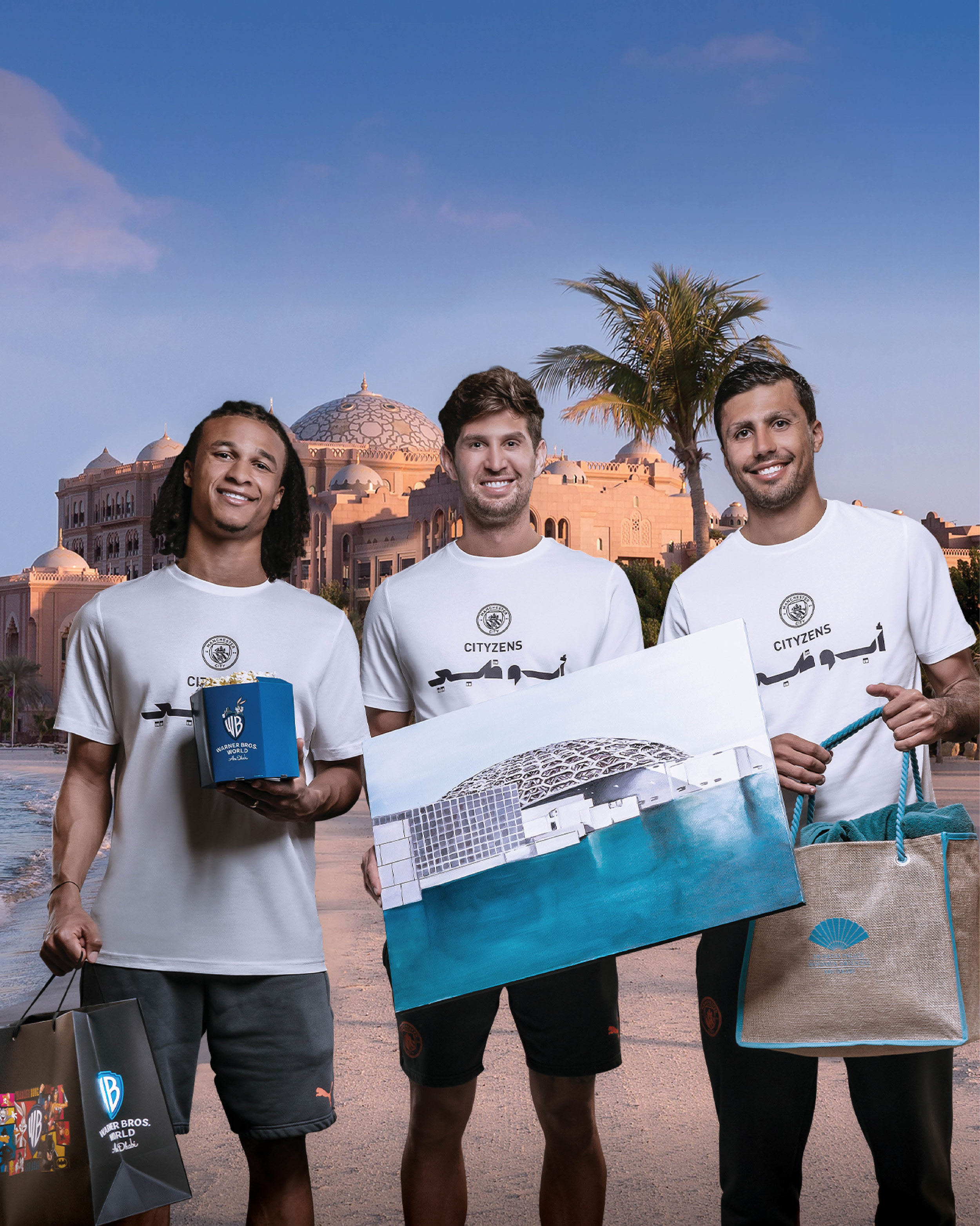 Three smiling men in matching "CITYZENS" t-shirts holding Abu Dhabi-themed souvenirs in front of an ornate palace-like building.