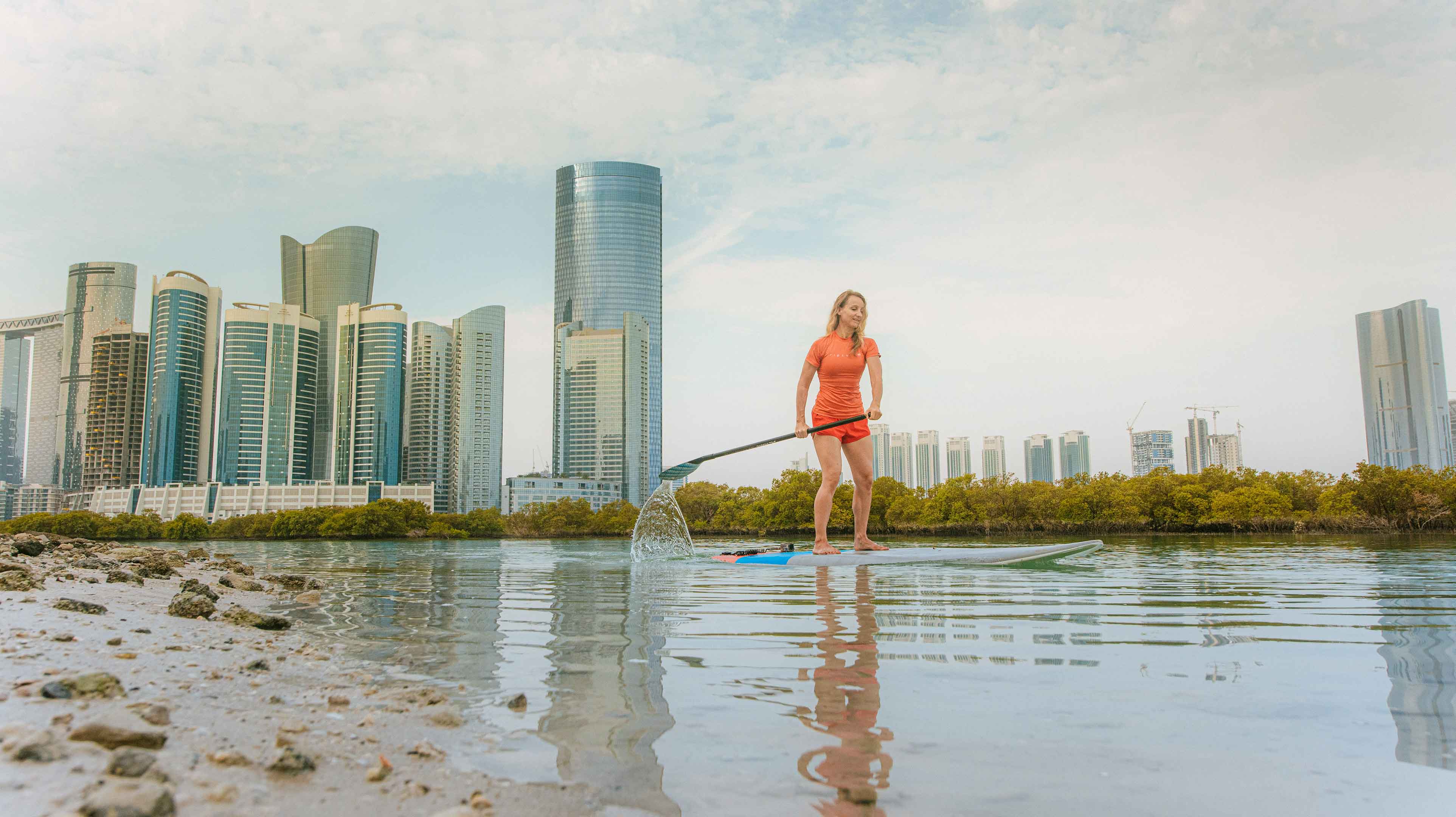 Woman stand up paddleboarding in Abu Dhabi