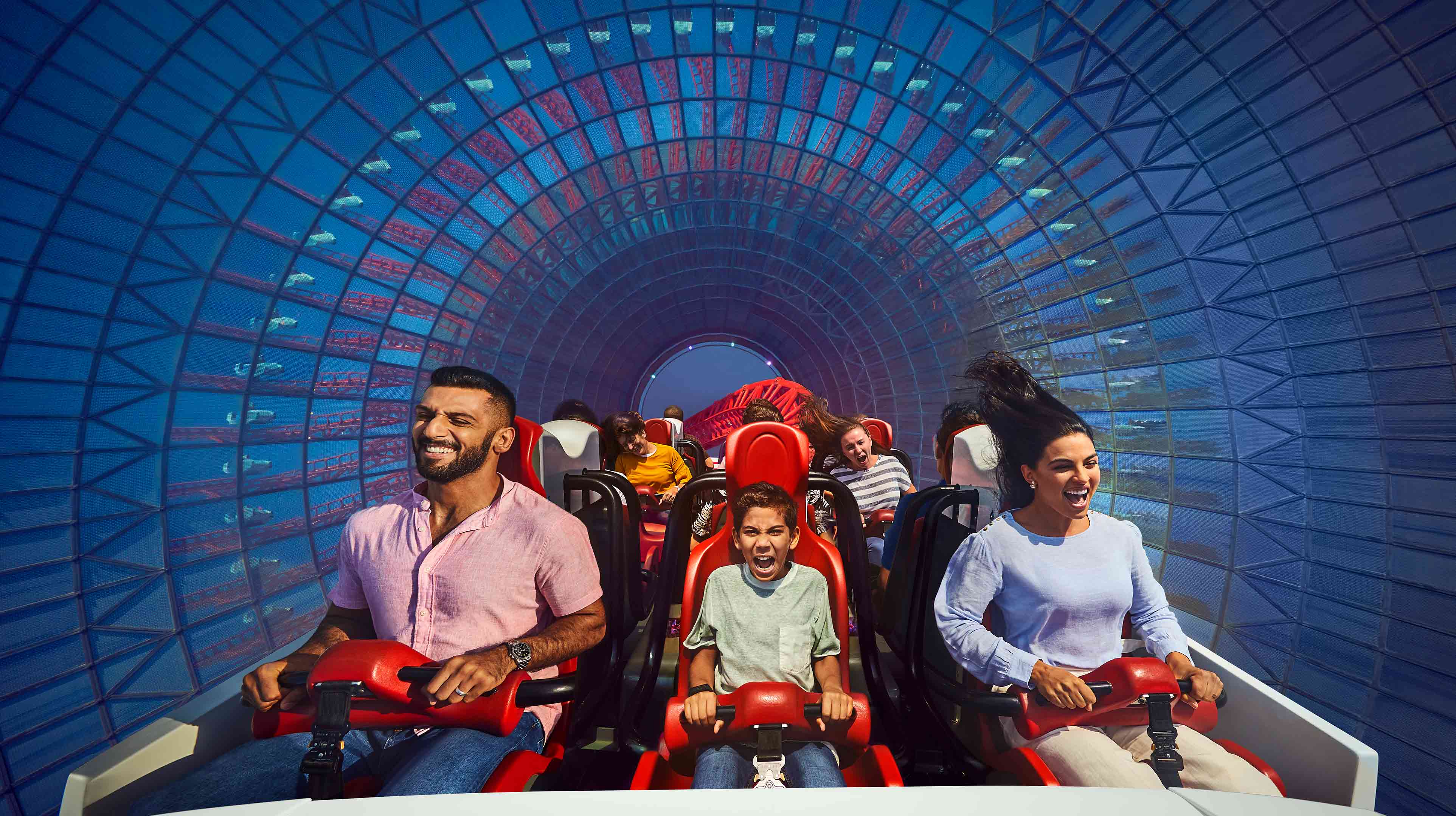Family of three enjoying their time on a rollercoaster in Abu Dhabi
