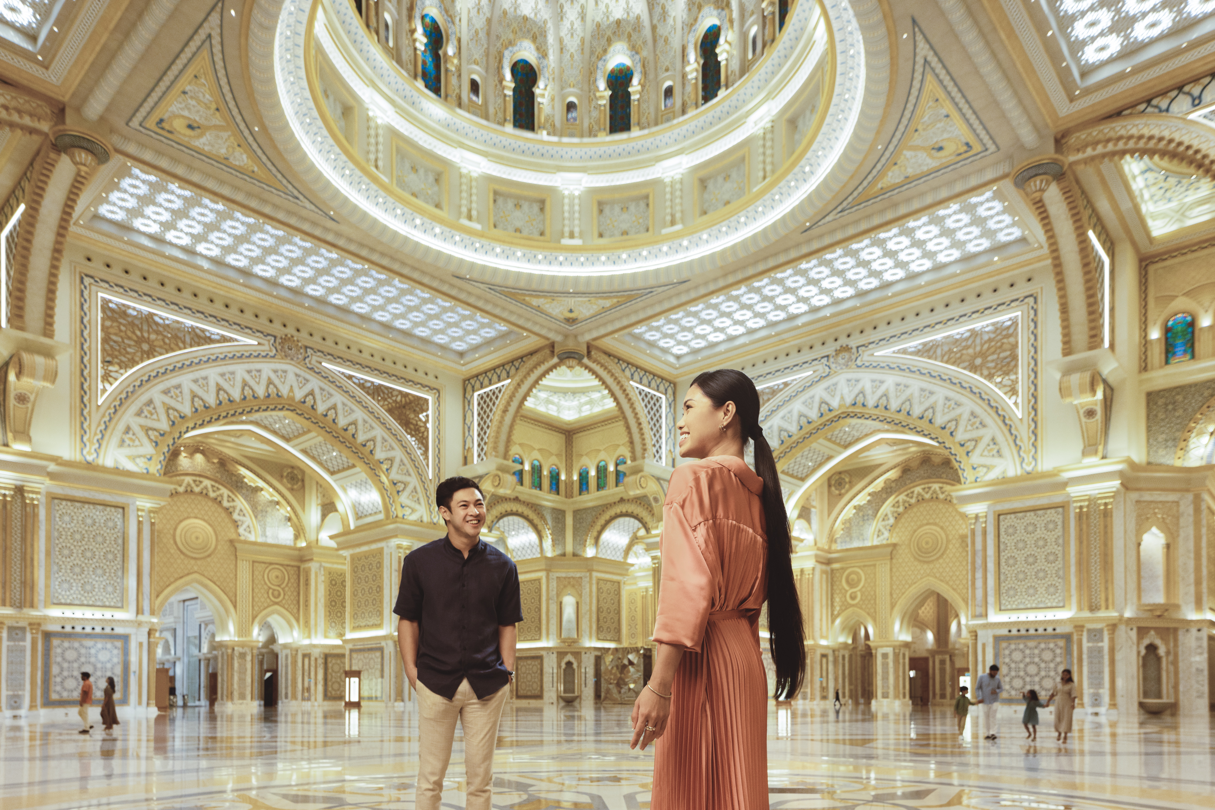 Asian couple smiling in Qasr Al Watan palace courtyard in Abu Dhabi