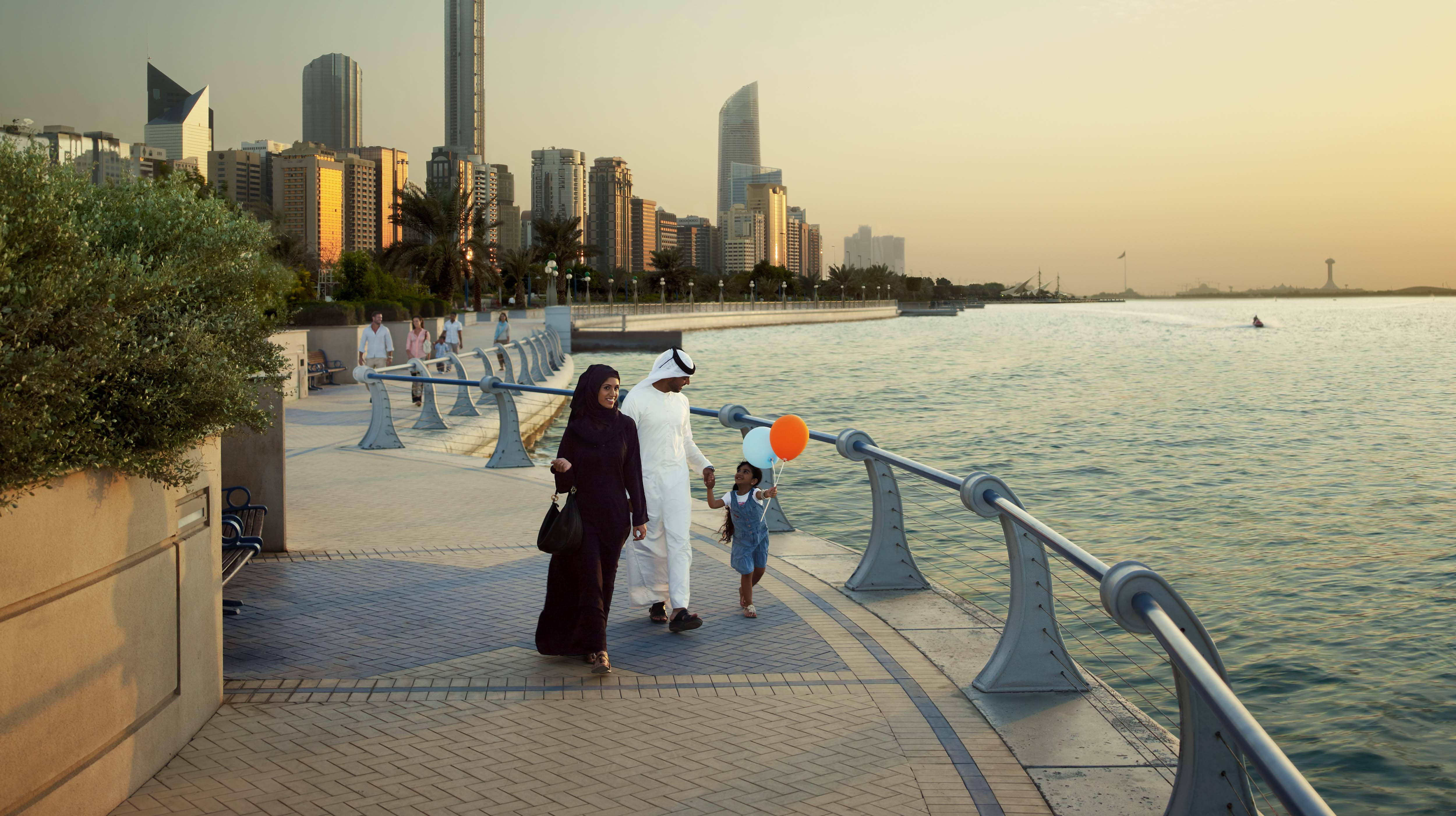 Emirati family walking along one of the promenades in Abu Dhabi