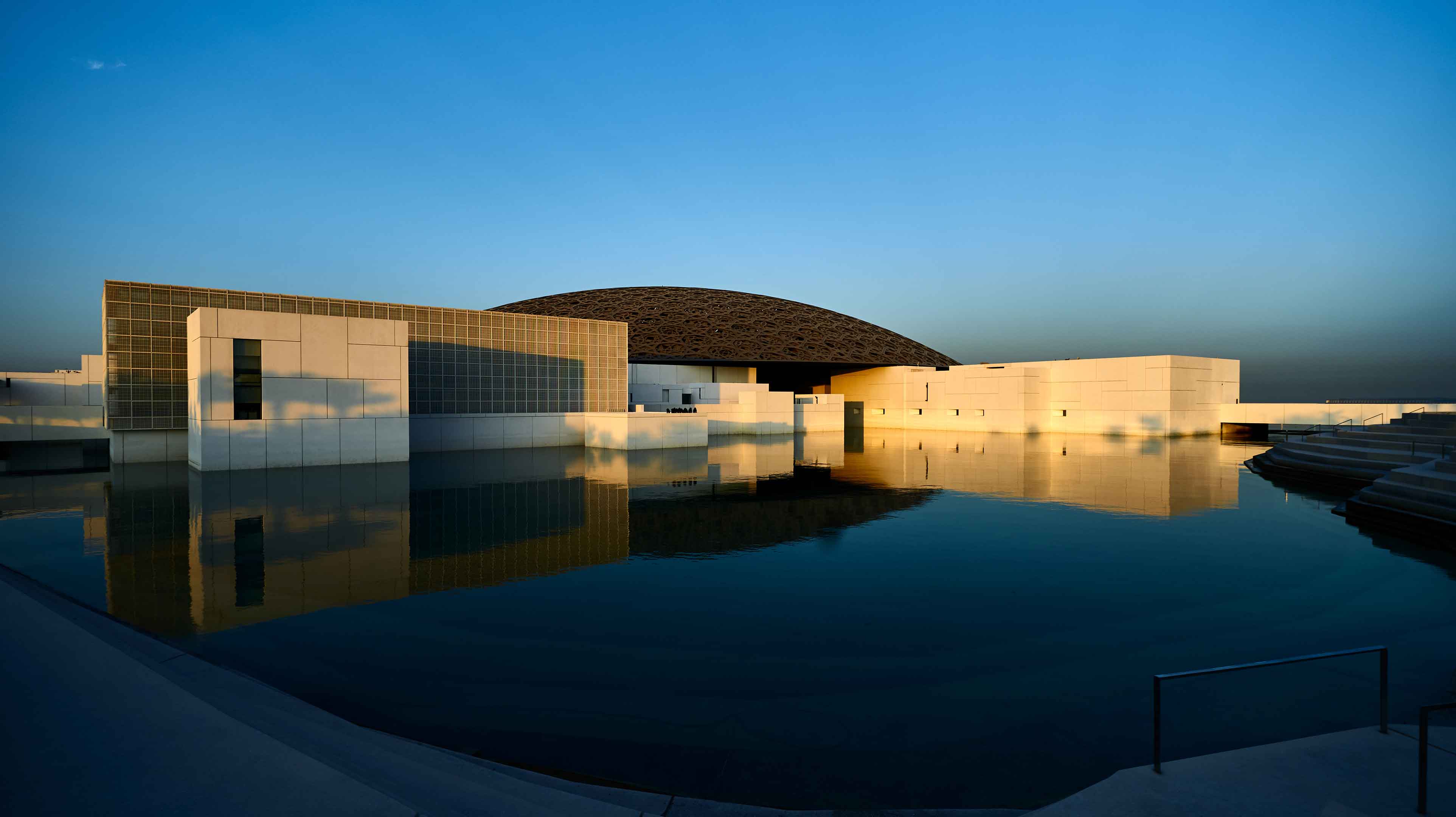 Louvre Abu Dhabi building with water in front