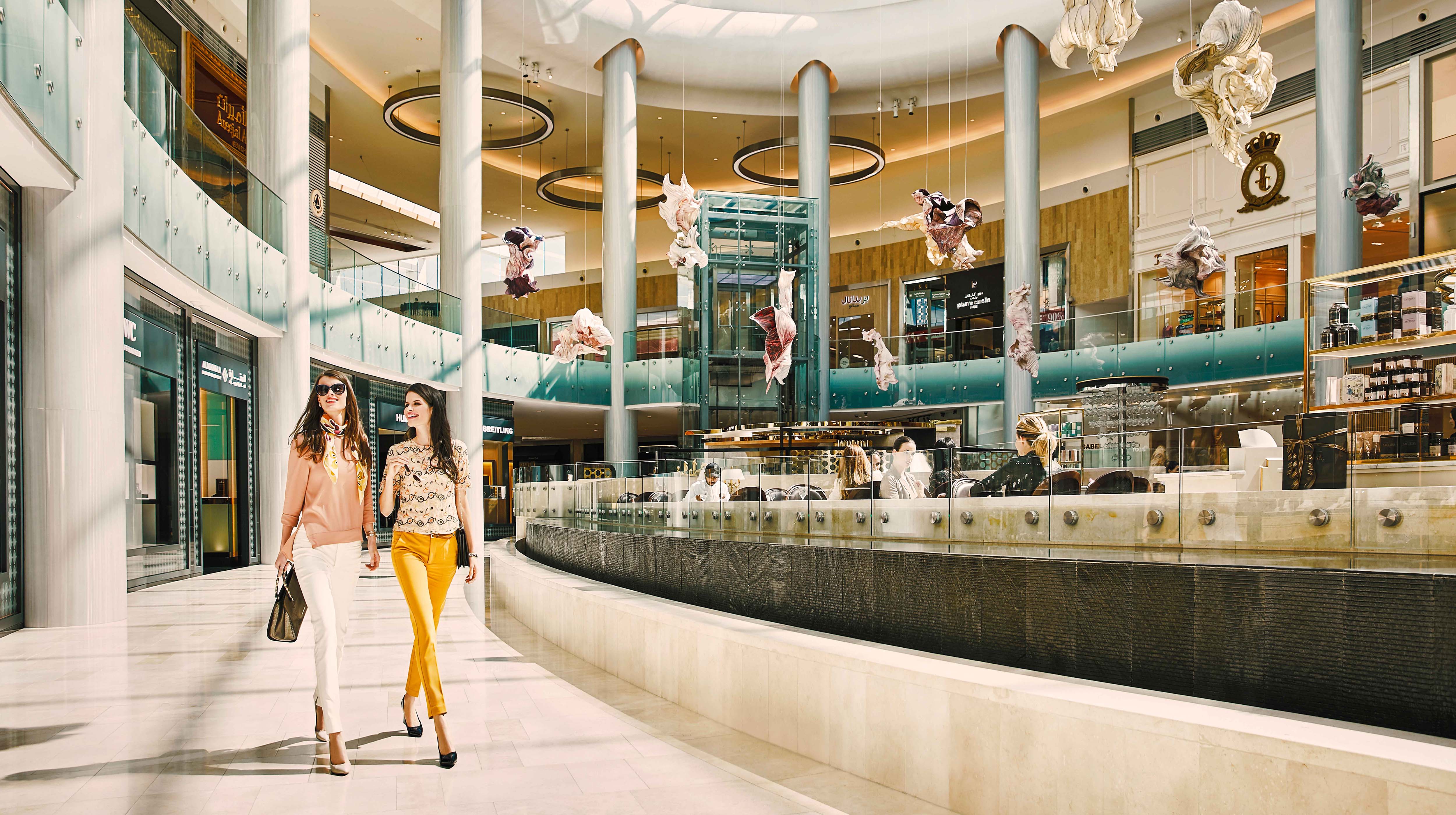 Two ladies chatting as they shop in one of Abu Dhabi's malls