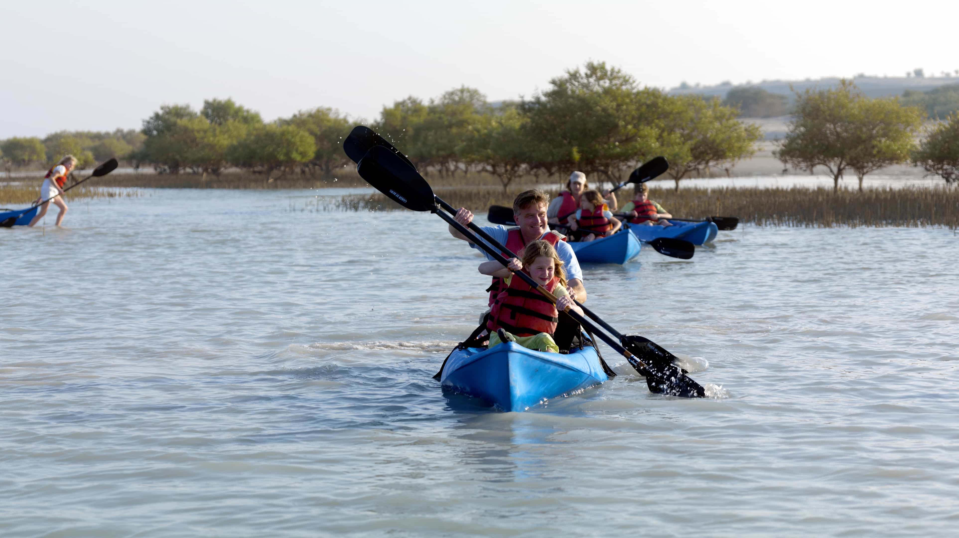 Western father kayaking in Abu Dhabi with his daughter 