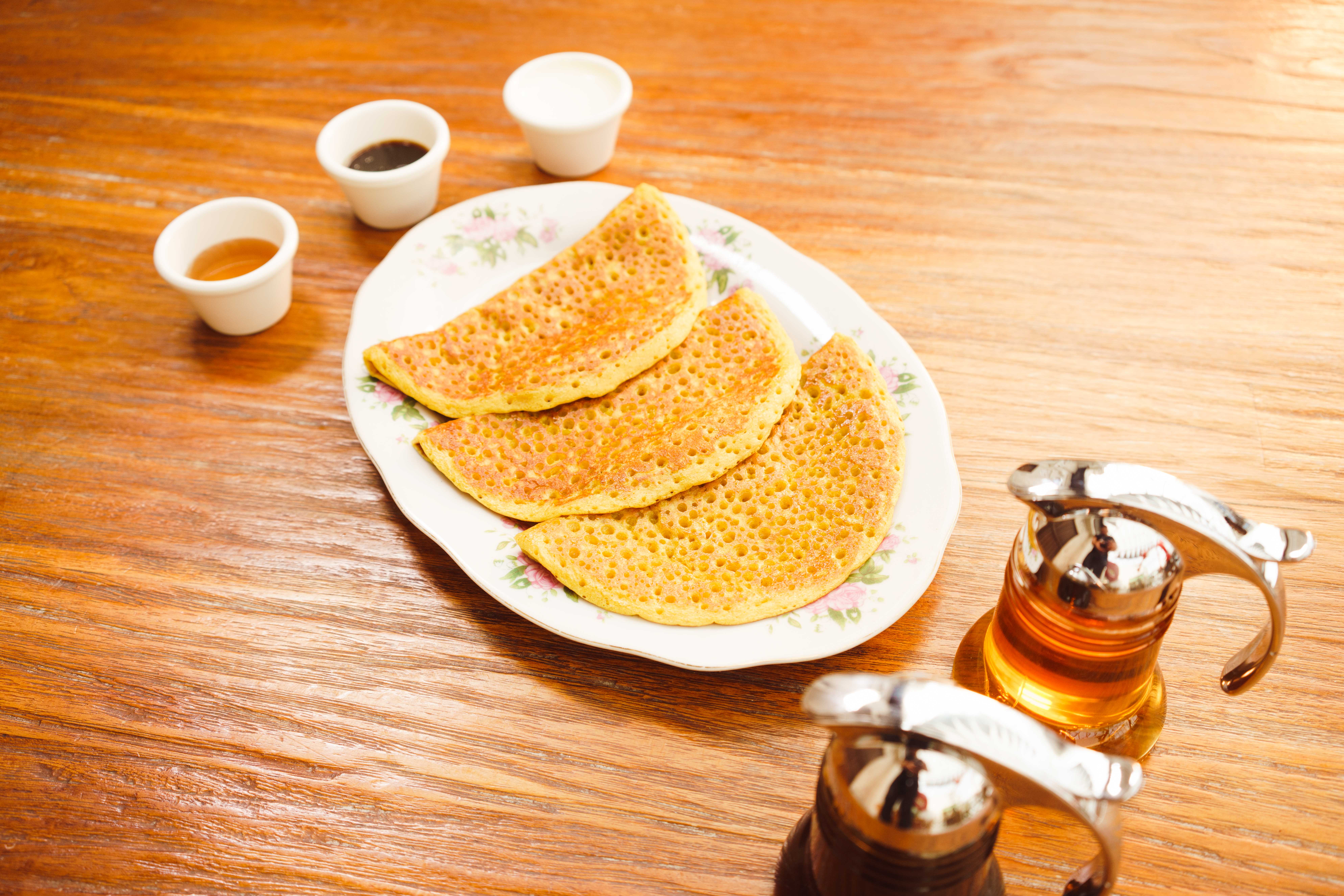  Dégustez une spécialité de la cuisine émiratie : des crêpes dorées accompagnées de sauces savoureuses, reflet des traditions culinaires des Émirats arabes unis.