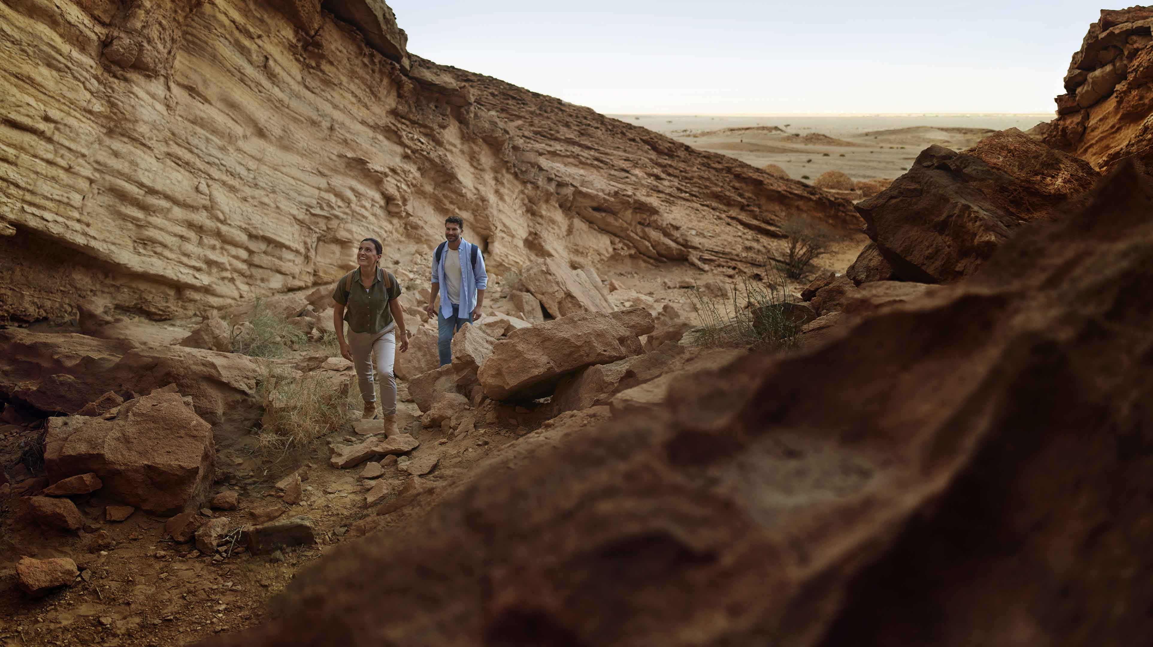 Western couple walking through a canyon in Abu Dhabi