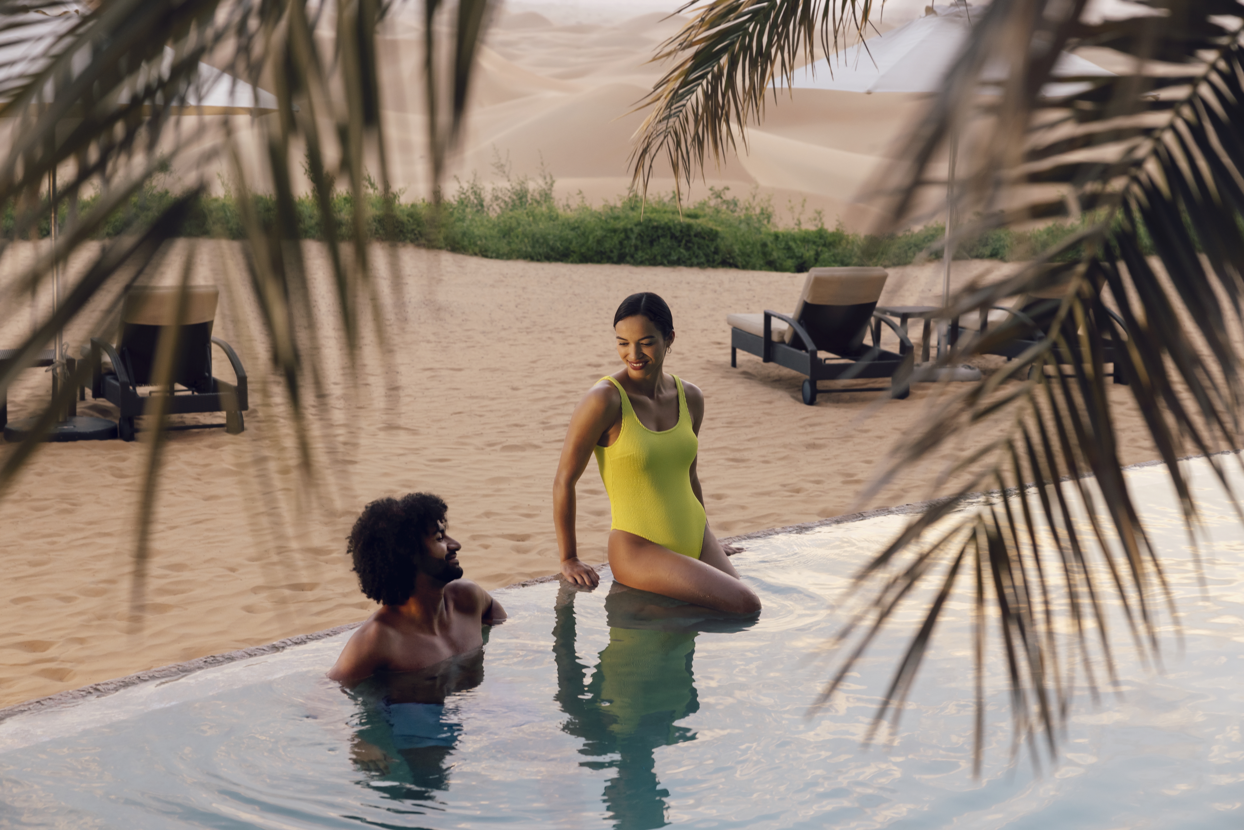 Western couple in pool at Telal resort in Abu Dhabi dunes