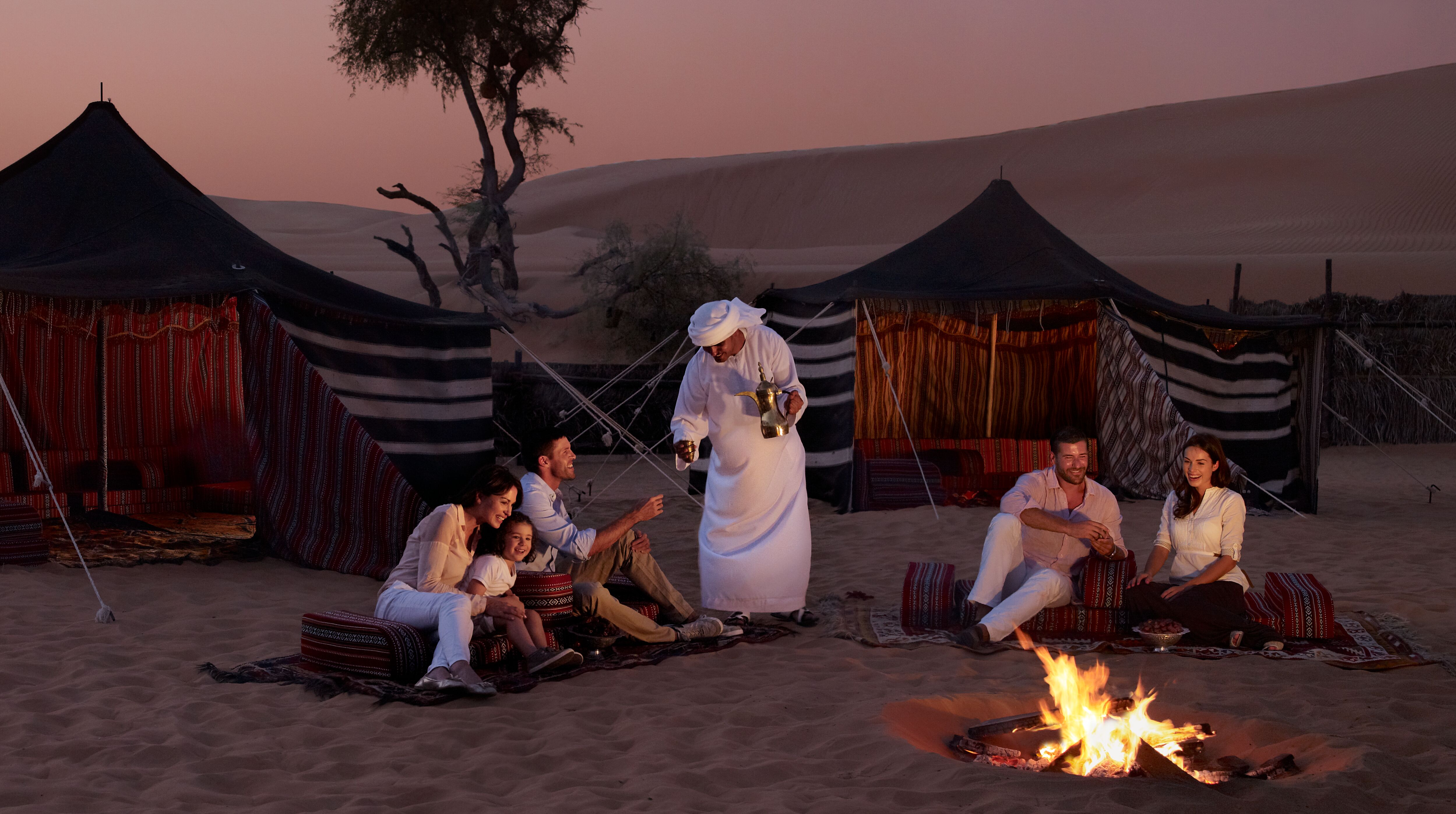 Local guide giving tourists refreshments in the Arabian Nights Vollage in Abu Dhabi