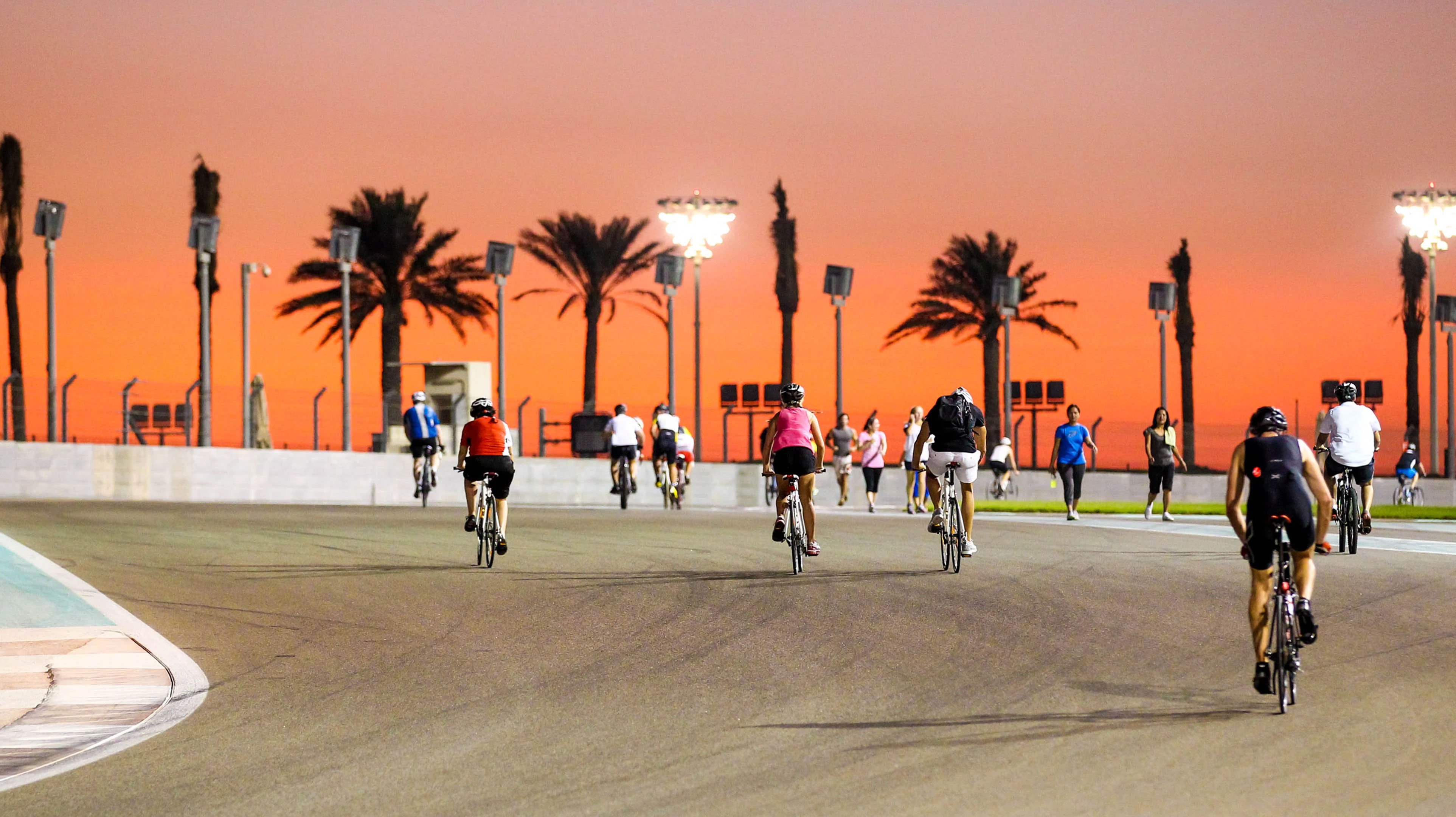 Casual cyclists riding bicycles on the Abu Dhabi Yas Marina Circuit