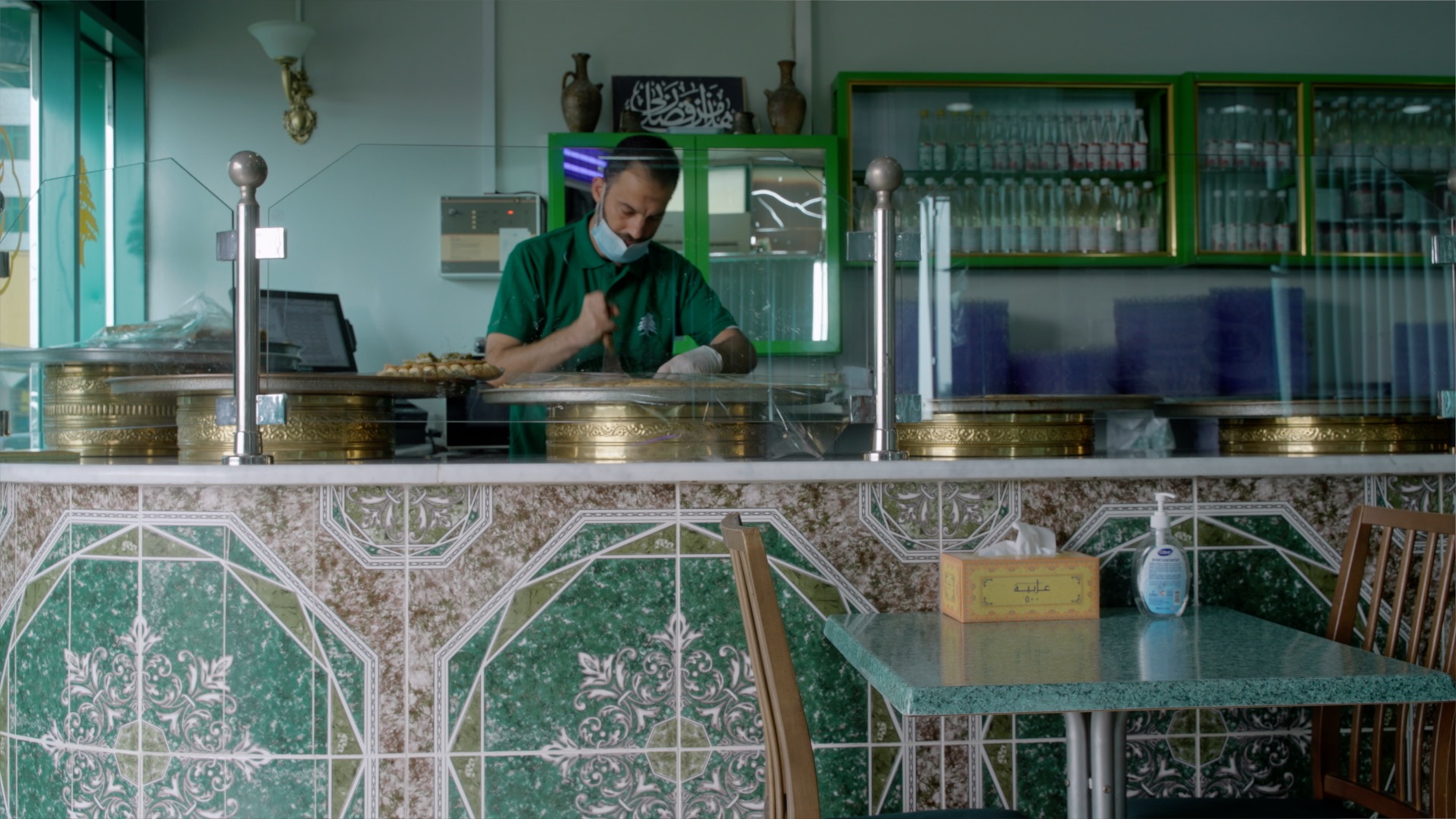 Man cutting Arabic sweets at Tripoli Sweets
