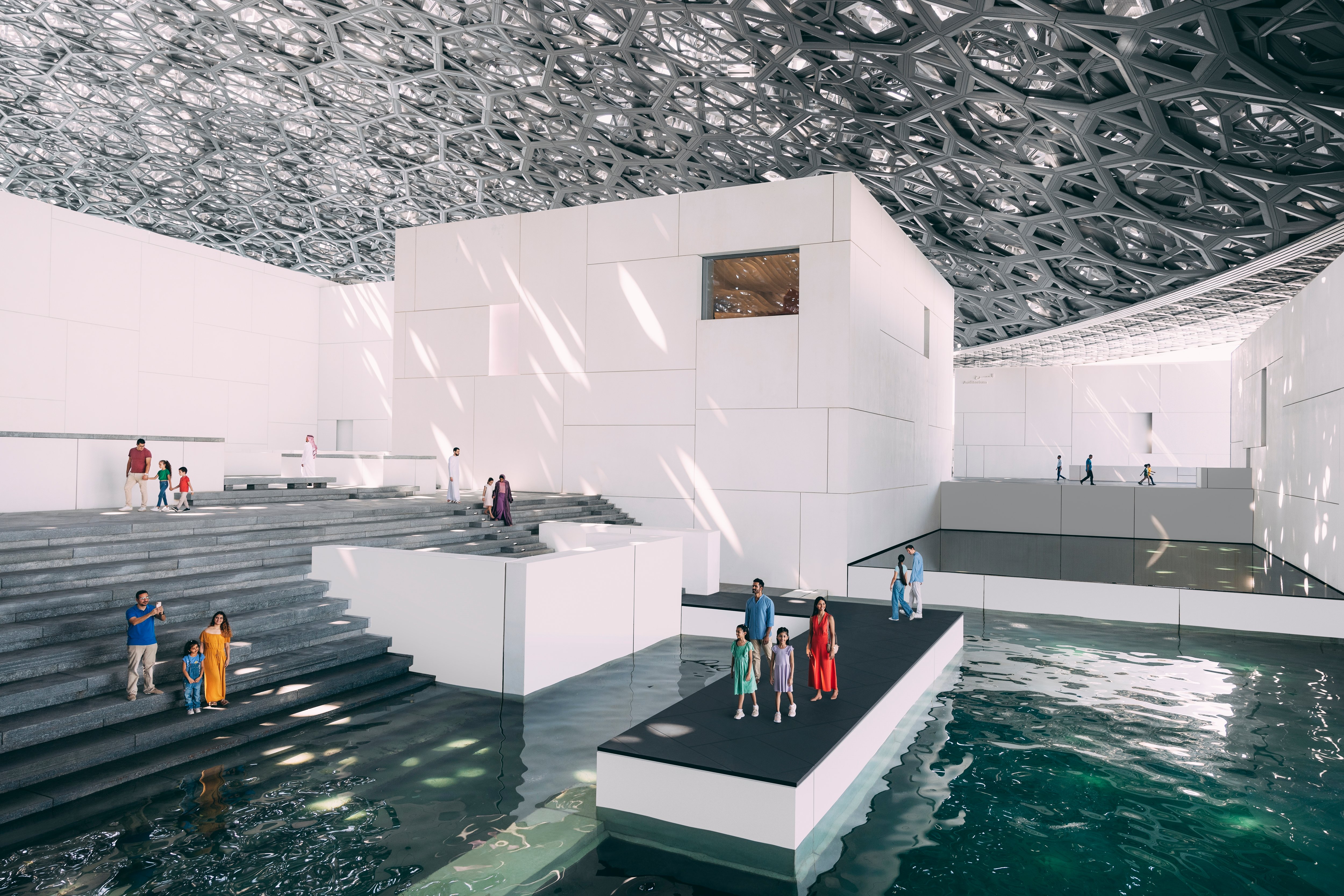 Tourists looking up at the dome above the Louvre Abu Dhabi