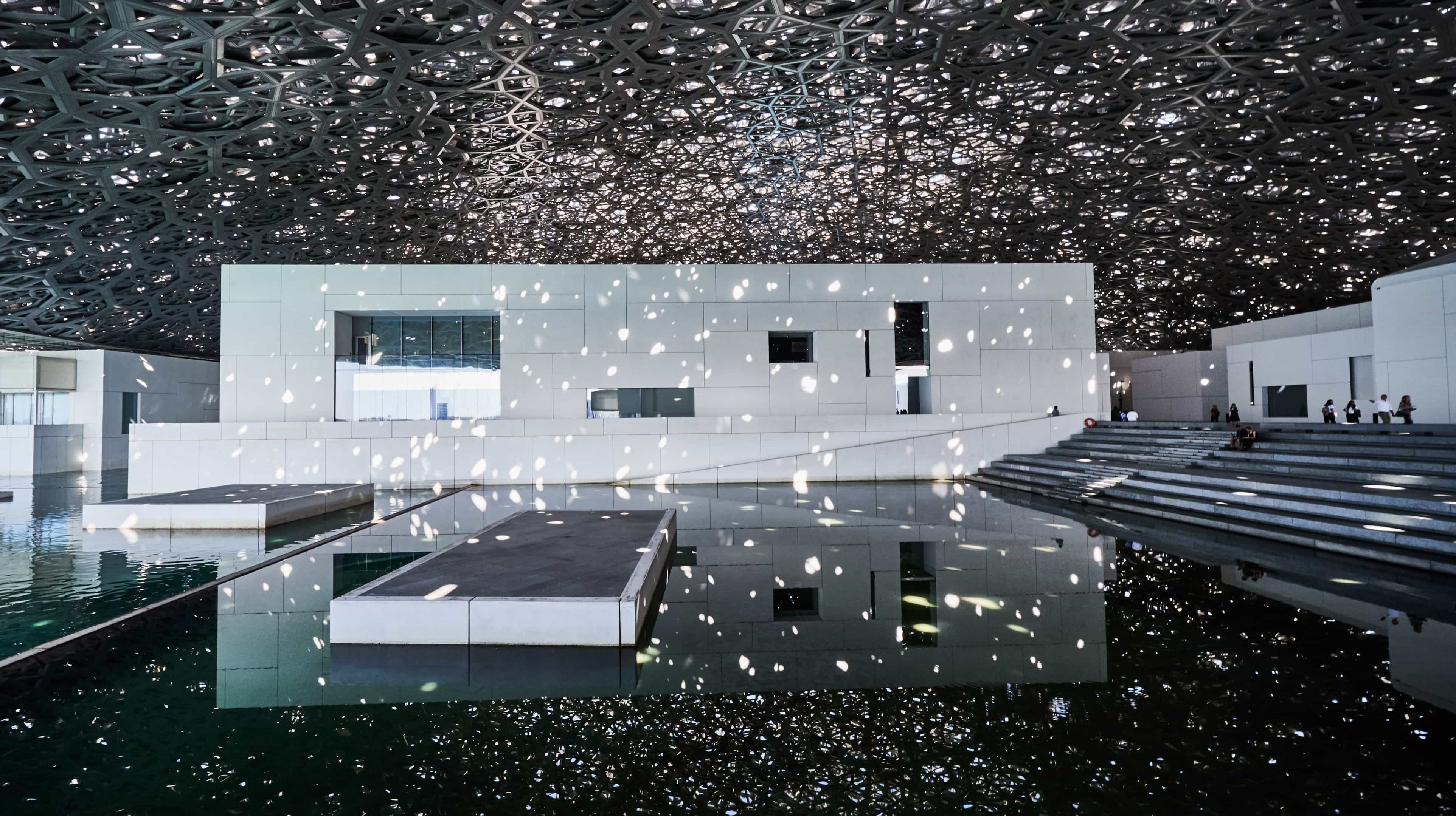 Sunshine creating patterns of light in the exernal seating area of Louvre Abu Dhabi