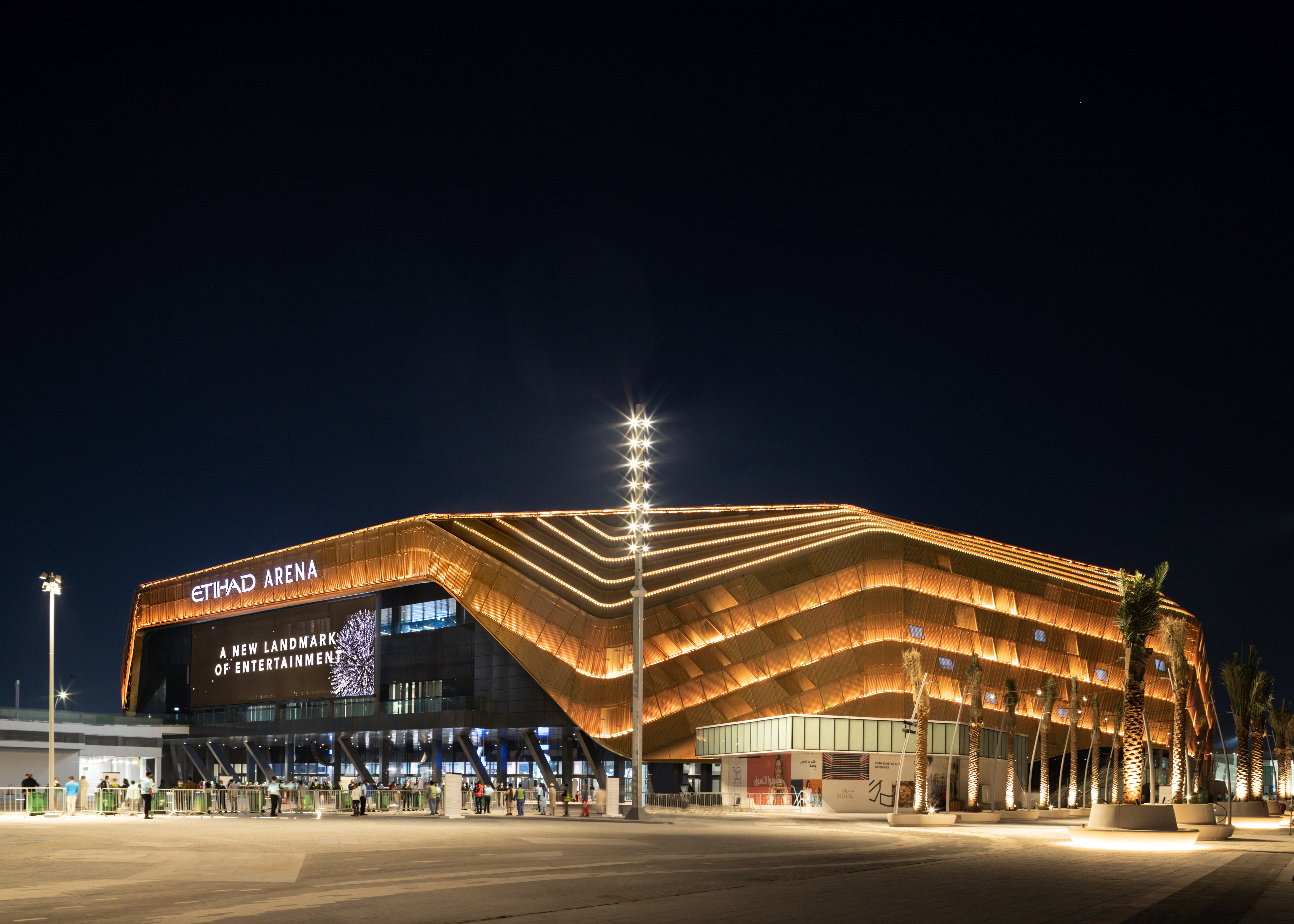 Exterior of Etihad Arena lit up at night