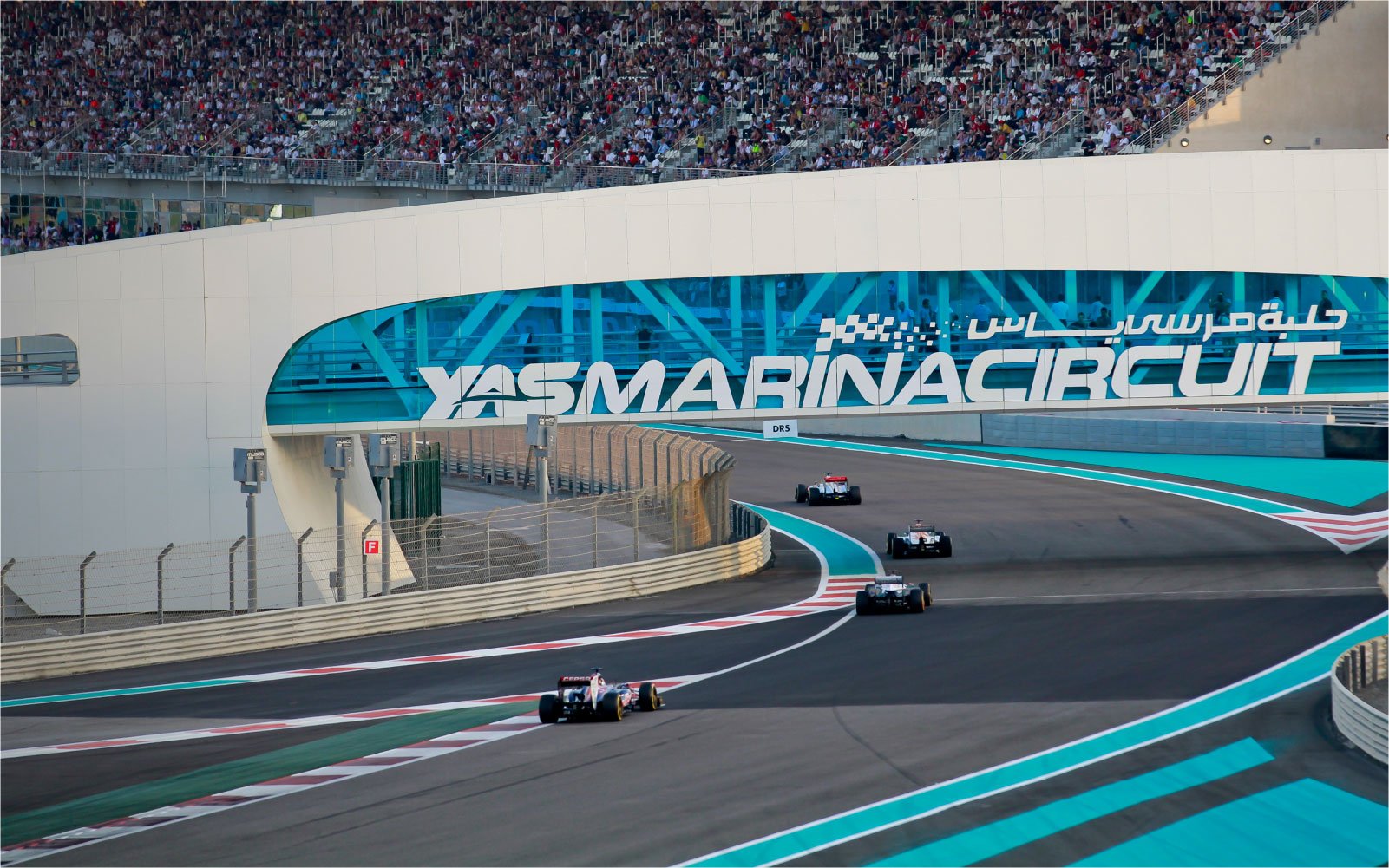 Four racecars on the track at Yas Marina Circuit