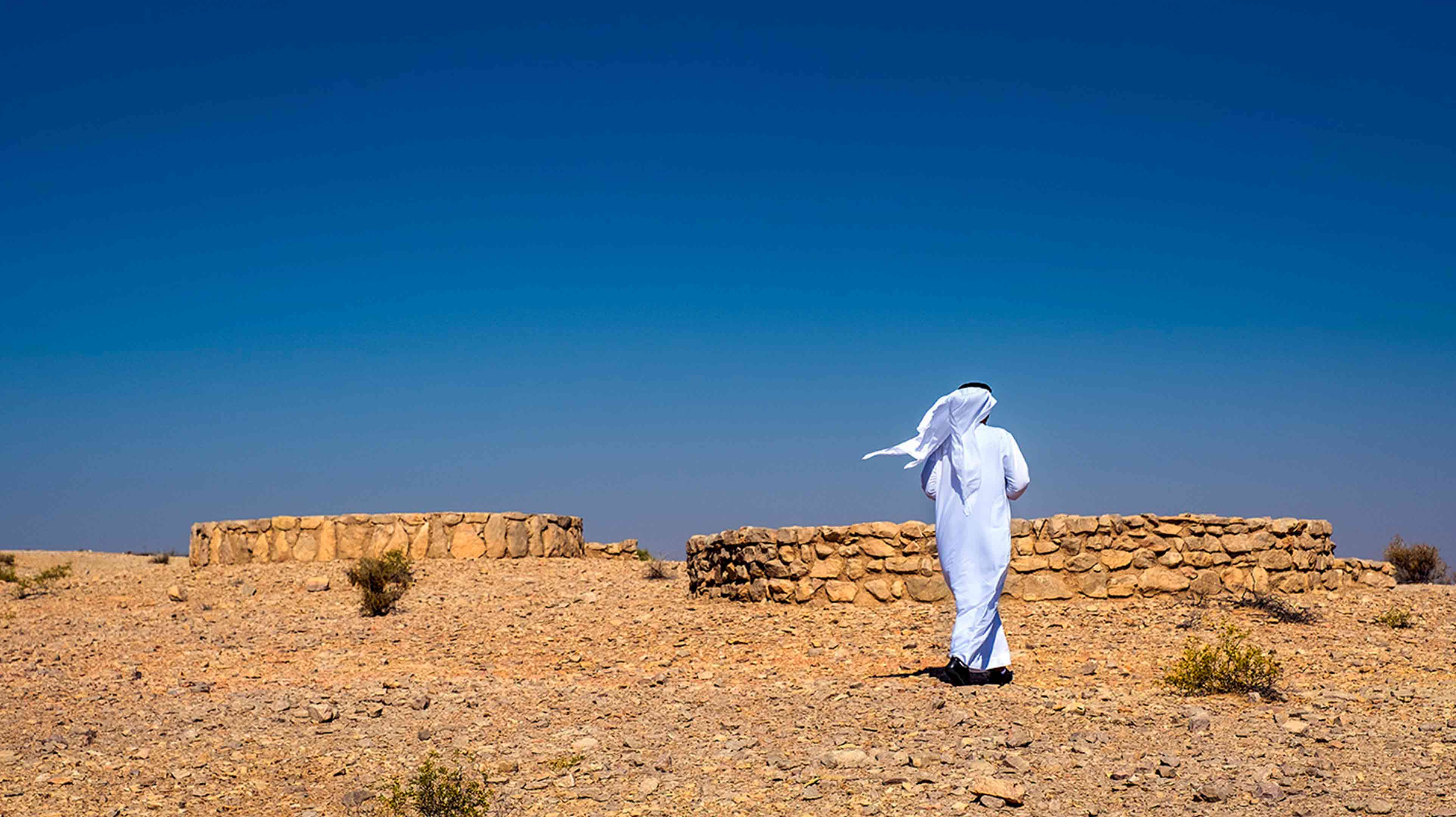 Emirati man exploring Bidaa Bint Saud, one of the UNESCO World Heritage sites in Abu Dhabi