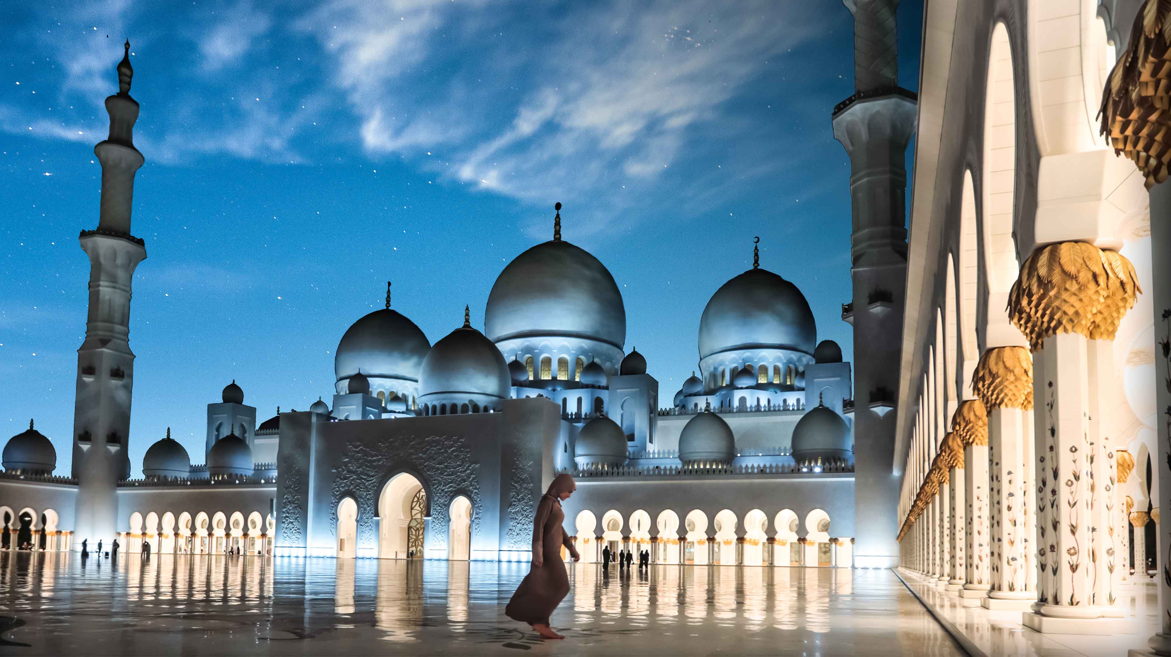 Woman outside Sheikh Zayed Grand Mosque at night