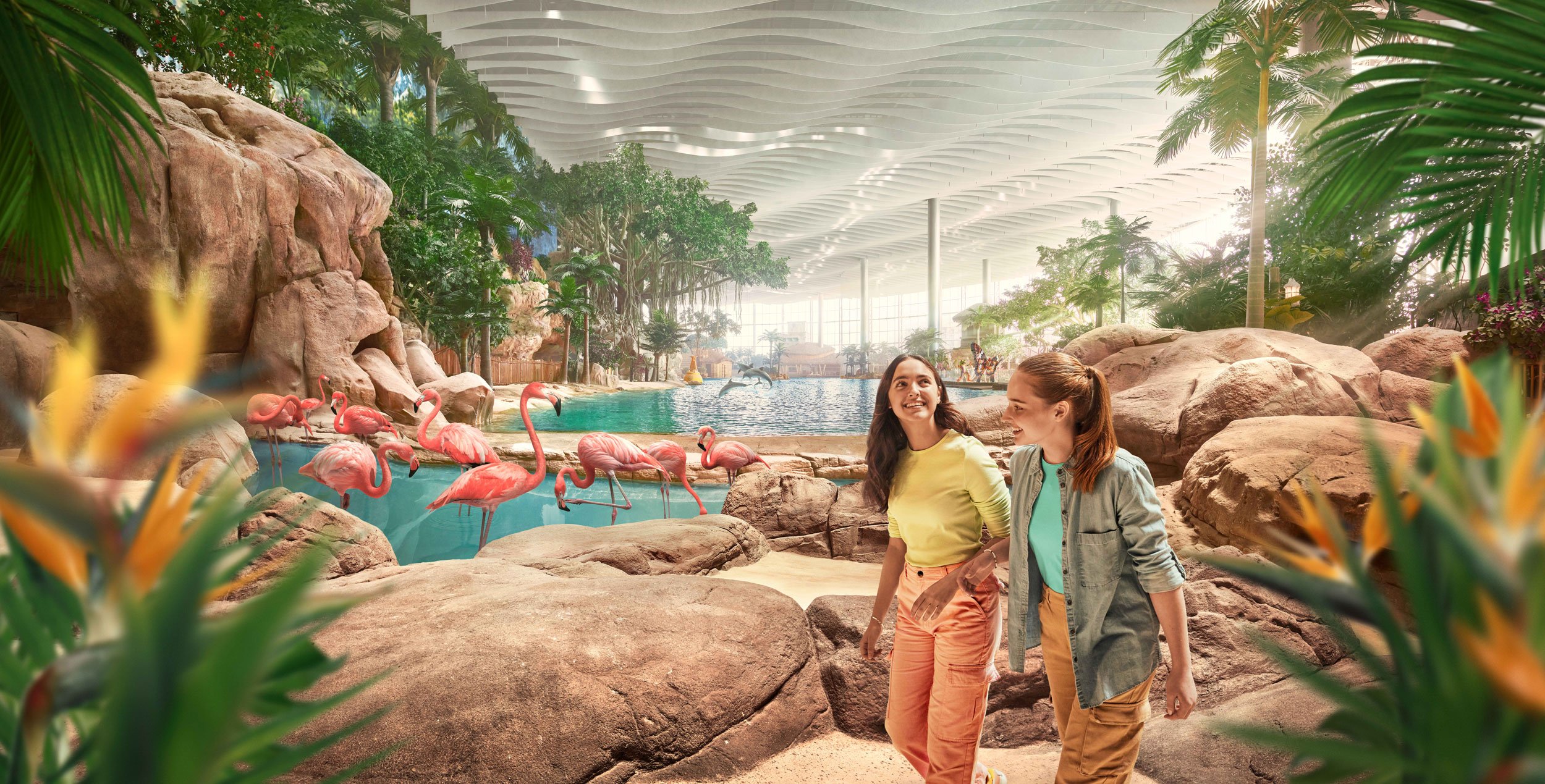 Due ragazze al Seaworld Abu Dhabi. Sullo sfondo ci sono piante tropicali e fenicotteri.