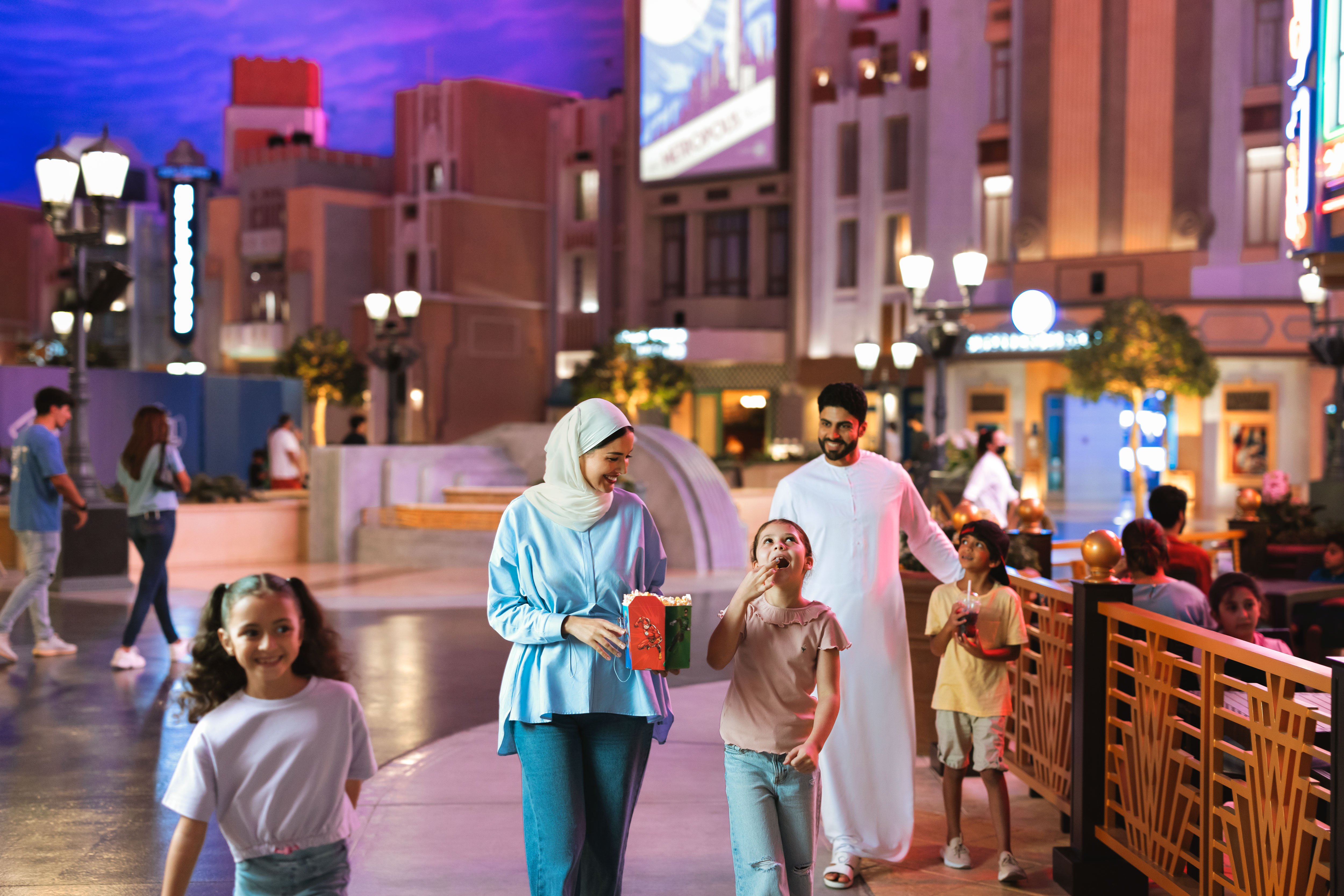 Arab family walking along in Warner Bros World Abu Dhabi