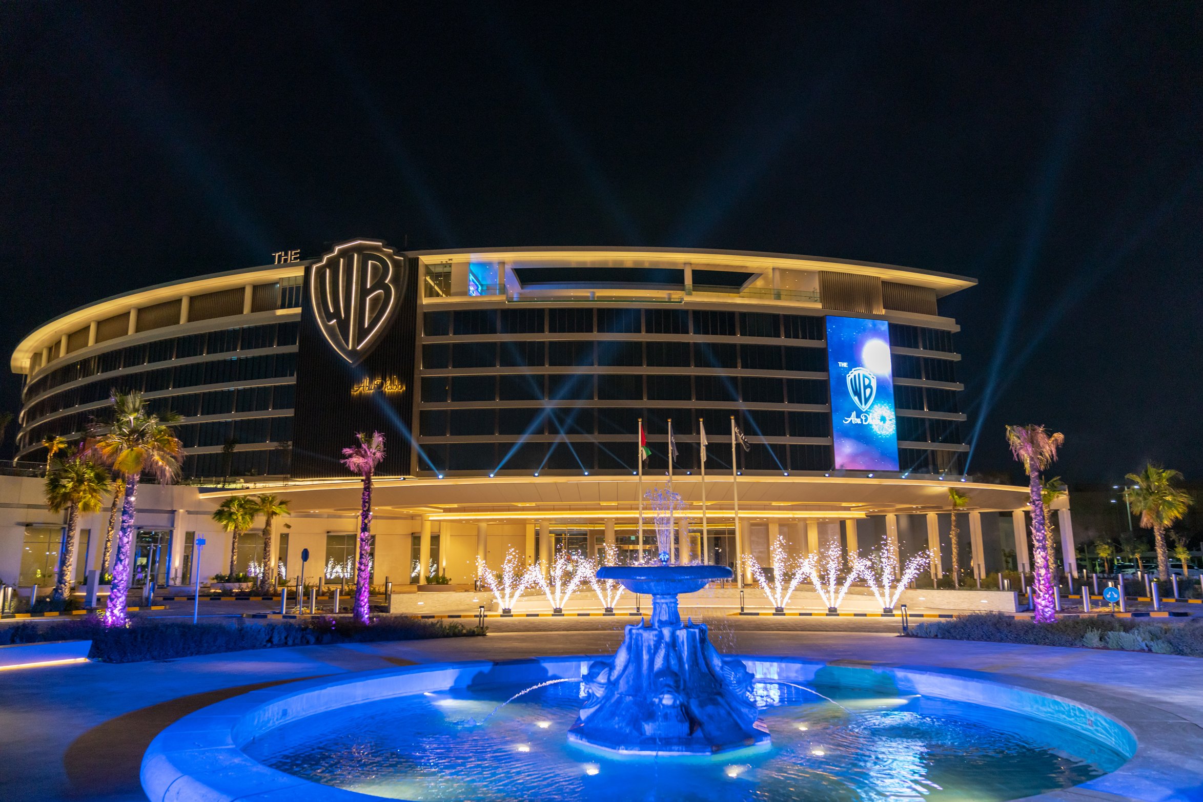 Exterior of the Warner Bros Abu Dhabi hotel lit up at night